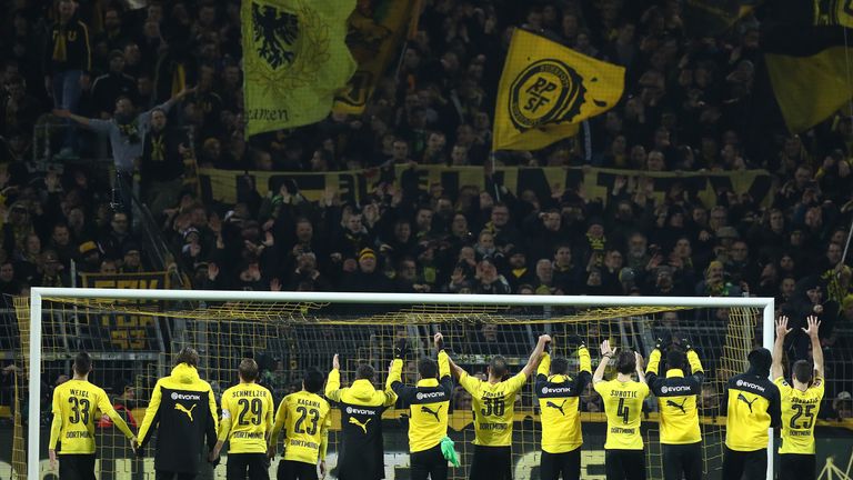 DORTMUND, GERMANY - DECEMBER 16: Players of Dortmund celebrate in front of their supporters after the Bundesliga match bet