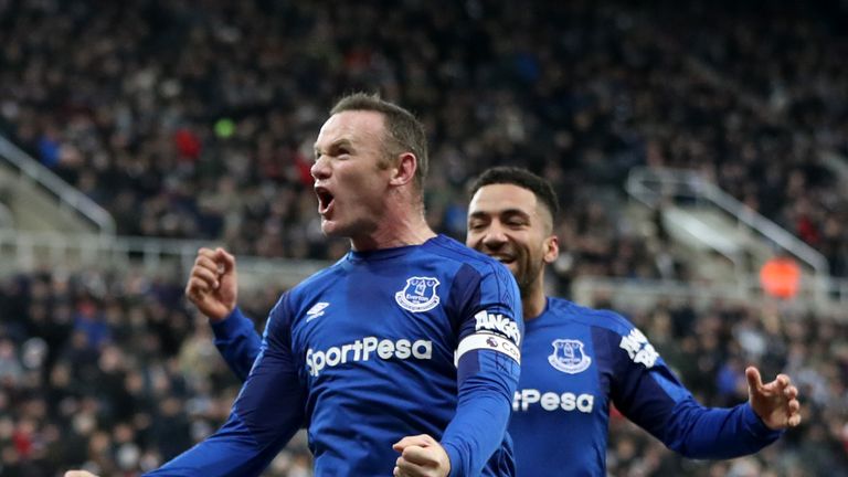 Wayne Rooney celebrates after scoring his side's first goal with Aaron Lennon of Everton during the Premier League match at Newcastle