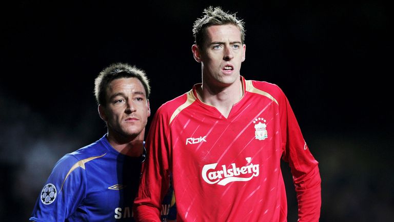 LONDON - DECEMBER 06:  John Terry of Chelsea marks Peter Crouch of Liverpool during the UEFA Champions League Group G match between Chelsea and Liverpool a