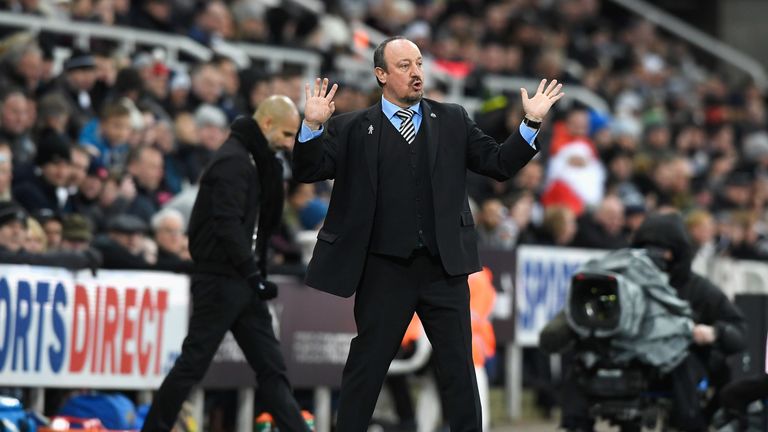 NEWCASTLE UPON TYNE, ENGLAND - DECEMBER 27: Rafael Benitez, Manager of Newcastle United gestures with Josep Guardiola, Manager of Manchester City during th