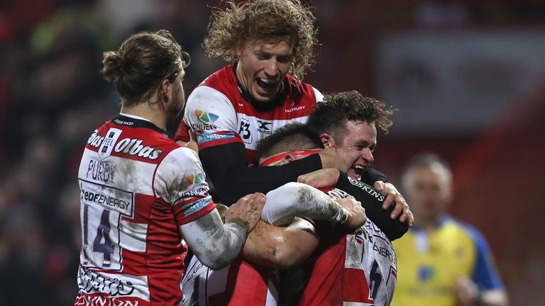 GLOUCESTER, ENGLAND - DECEMBER 02:  Jake Polledri of Gloucester is mobbed by his team mates after scoring a try during the Aviva Premiership match between 