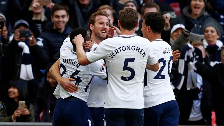 Harry Kane celebrates with team-mates after he scores the opening goal of the game