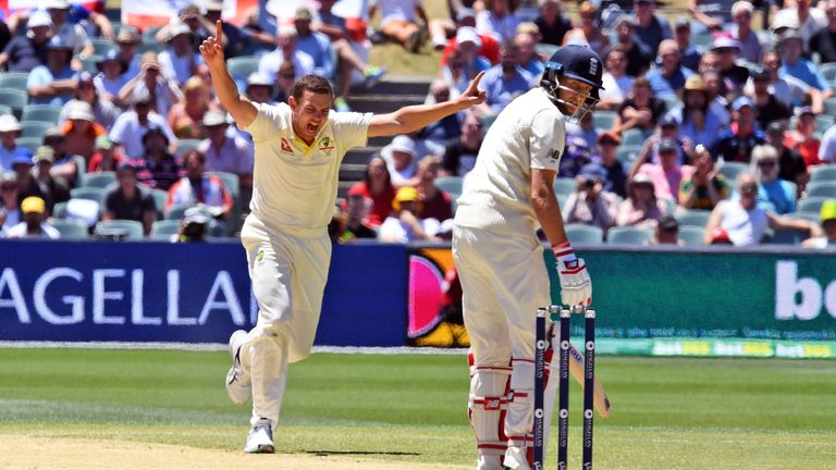 Australia's paceman Josh Hazlewood (L) celebrates dismissing England batsman Joe Root (R) on the final day of the second Ashes cricket Test match in Adelai