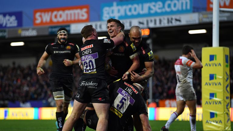 Henry Slade is swarmed by Chiefs team-mates after scoring a try