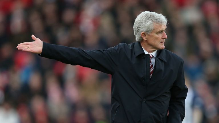 STOKE ON TRENT, ENGLAND - DECEMBER 23: Mark Hughes, Manager of Stoke City gives his team instructions during the Premier League match between Stoke City an