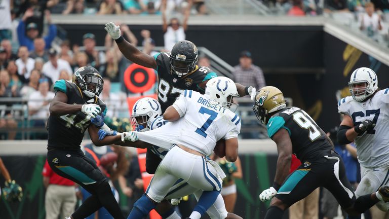 JACKSONVILLE, FL - DECEMBER 03:  Jacoby Brissett #7 of the Indianapolis Colts is pressured by a group of Jacksonville Jaguars defenders in the second half 