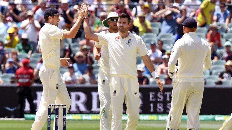 England paceman James Anderson (C) celebrates with teammates after dismissing Australian batsman Peter Handscomb on the fourth day of the second Ashes cric