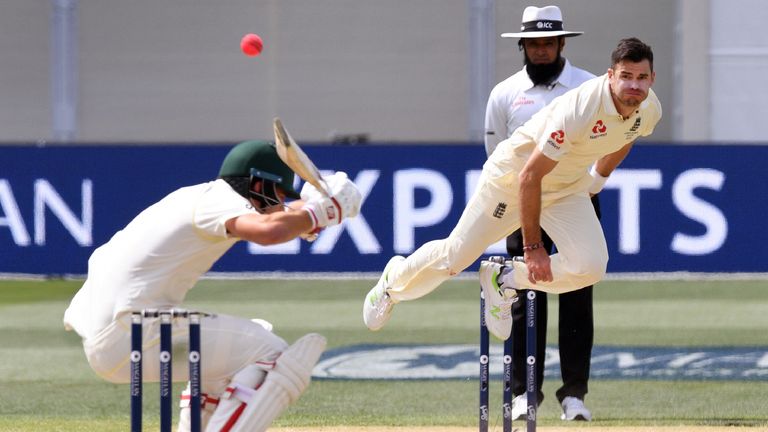 England paceman James Anderson (R) sends down a delivery to Australian batsman Pat Cummins (L) on the way to capturing five wickets on the fourth day of th