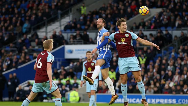BRIGHTON, ENGLAND - DECEMBER 16: Glenn Murray of Brighton and Hove Albion wins a header over James Tarkowski of Burnley during the Premier League match bet
