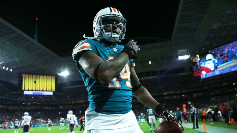 MIAMI GARDENS, FL - DECEMBER 11:   Jarvis Landry #14 of the Miami Dolphins celebrates a touchdown by teammate  Jakeem Grant #19 in the third quarter agains