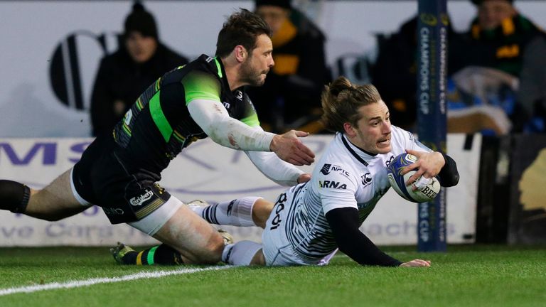 NORTHAMPTON, ENGLAND - DECEMBER 09 2017: Jeff Hassler of Ospreys scores a try despite the efforts of Ben Foden of Northampton