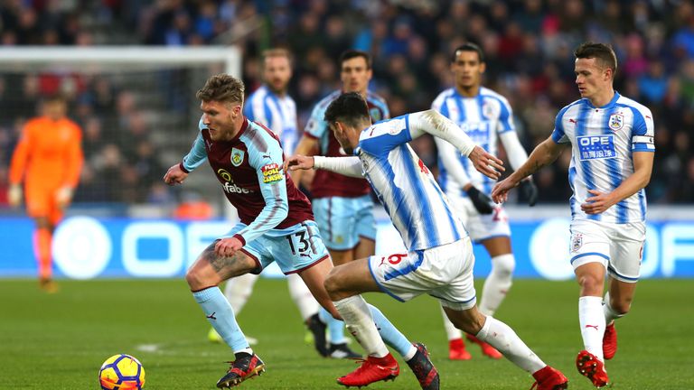 Jeff Hendrick of Burnley and Christopher Schindler of Huddersfield Town battle for possession