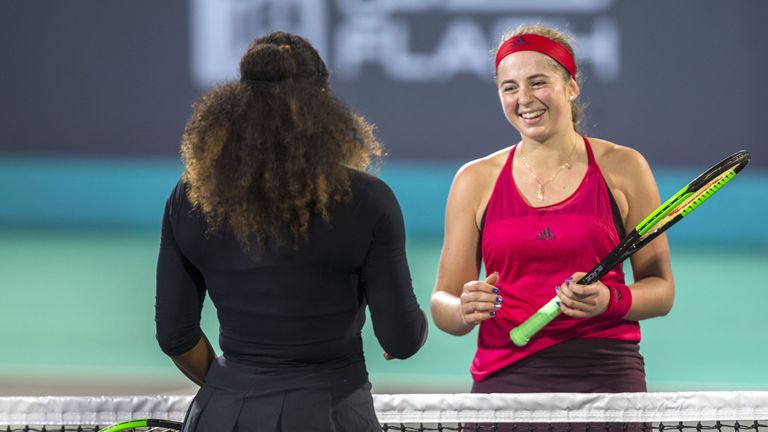 Jelena Ostapenko of Latvia (R) smiles and greets Serena Williams of the US after winning against her during the Mubadala World Tennis Championship 