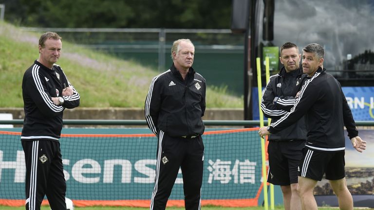 Northern Ireland's main coach Neill O'Neill (L) and assistant coach Jimmy Nicholl (2ndL) attend a training session at the team's training ground in Saint-G