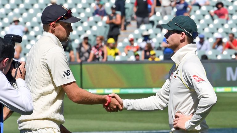 Australia's captain Steve Smith (R) shakes hands with England captain Joe Roor after Australia defeated England on the final day of the second Ashes cricke