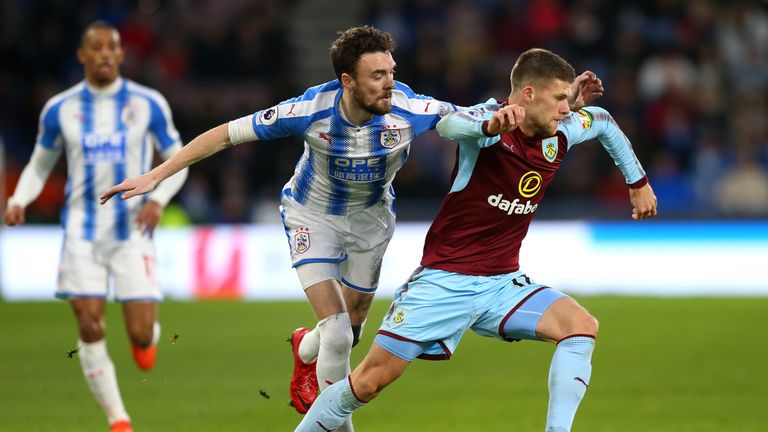 HUDDERSFIELD, ENGLAND - DECEMBER 30: Johann Gudmundsson of Burnley is challenged by Scott Malone of Huddersfield Town during the Premier League match betwe