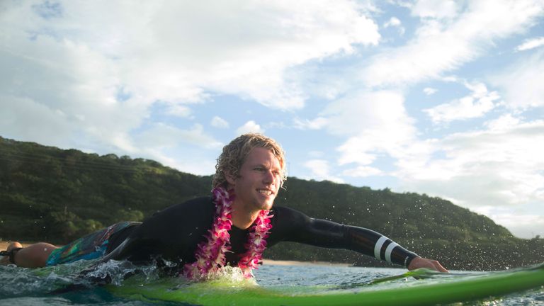 Big wave surfer John John Florence paddles out to perform a ceremony for the opening of the 2016 Quiksilver Eddie Aikau invitational big wave contest cerem