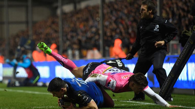 EXETER, ENGLAND - DECEMBER 10 2017:  Leinster player Johnny Sexton beats Henry Slade to score the opening try during the Champions Cup