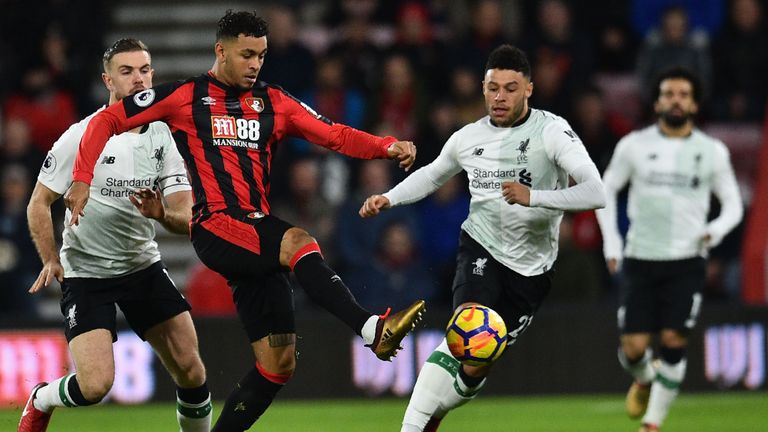 Joshua King (C) vies with Alex Oxlade-Chamberlain