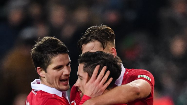 HANOVER, GERMANY - DECEMBER 17: Julian Korb #4 of Hannover 96 celebrates with his team-mates after scoring a goal to make it 4-4 during the Bundesliga matc