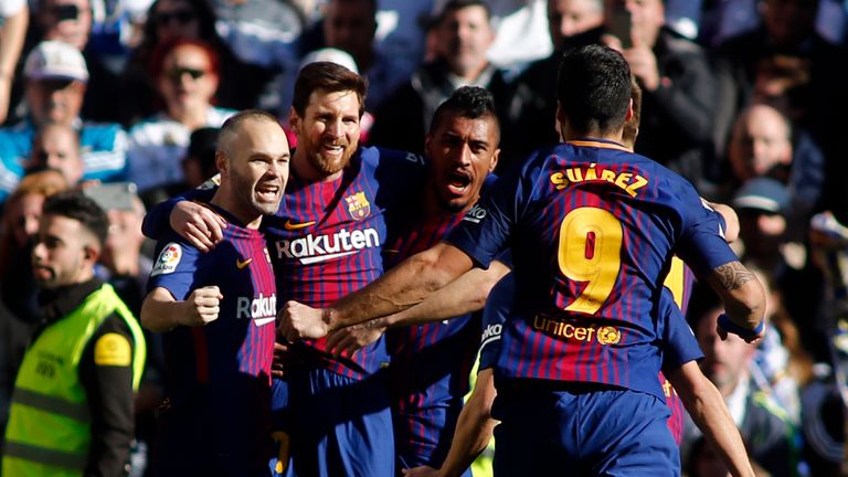 Lionel Messi is congratulated by Barcelona team-mates Andres Iniesta and Paulinho