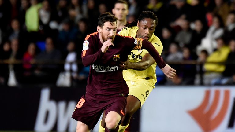 Barcelona's Lionel Messi (L) vies with Villarreal's Ruben Semedo during the Spanish league football match