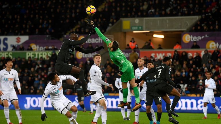SWANSEA, WALES - DECEMBER 13: Lukasz Fabianski of Swansea City punches the ball clear during the Premier League match between Swansea City and Manchester C