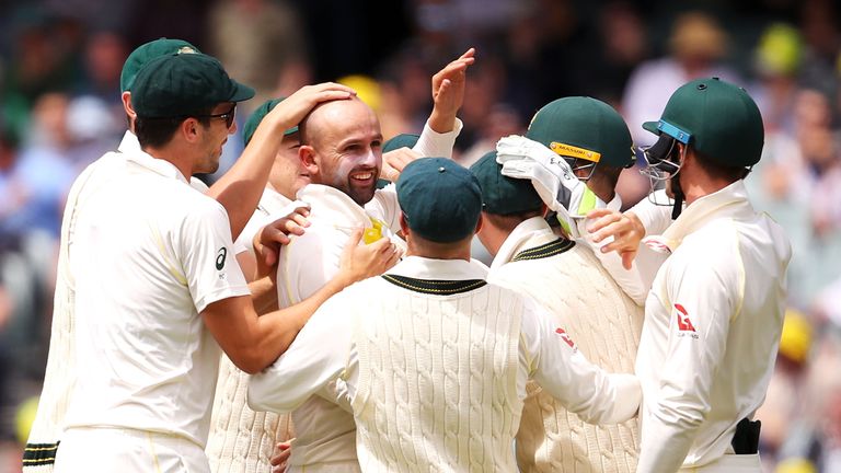 ADELAIDE, AUSTRALIA - DECEMBER 04:  Nathan Lyon of Australia celebrates with his team mates after taking the wicket of Alastair Cook of England  during day