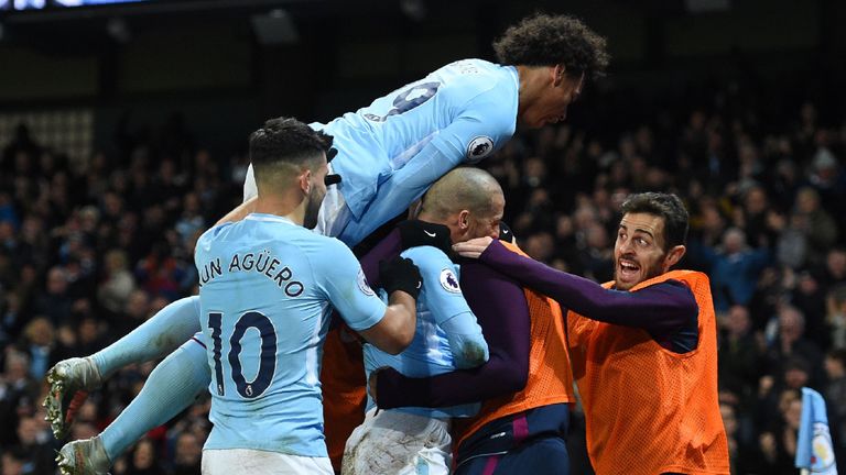 Manchester City's players and substitutes celebrates with Manchester City's Spanish midfielder David Silva (C) after he scores their second goal during the