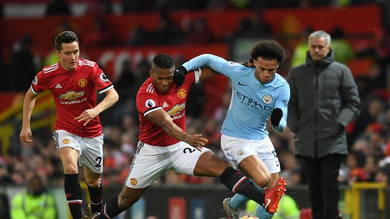 Leroy Sane and Antonio Valencia in action during the Manchester Derby at Old Trafford