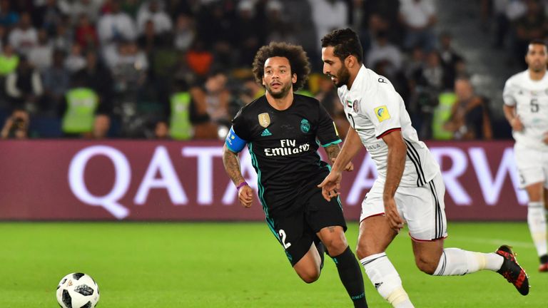 Al-Jazira's Emirati forward Ali Mabkhout (R) is marked by Real Madrid's Brazilian defender Marcelo during the FIFA Club World Cup semi-final match in the E