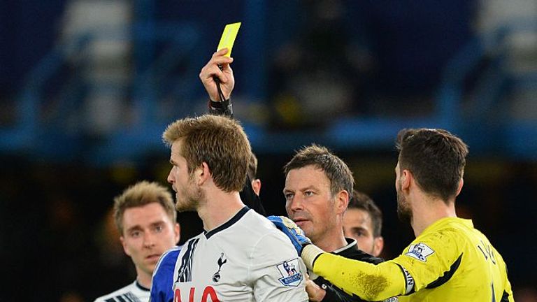 Eric Dier is shown a yellow card by Clattenburg on the ill-fated night 18 months ago