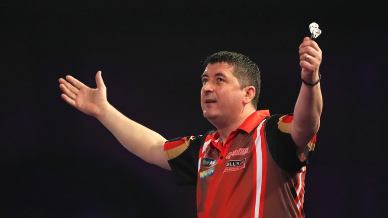 Mensur Suljovic celebrates his win on day five of the William Hill World Darts Championship at Alexandra Palace