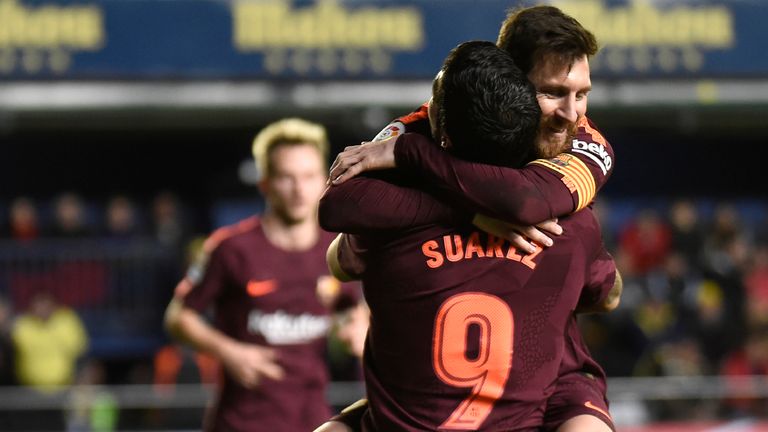 Barcelona's Argentinian forward Lionel Messi (L) celebrates  with Barcelona's Uruguayan forward Luis Suarez after scoring during the Spanish league footbal