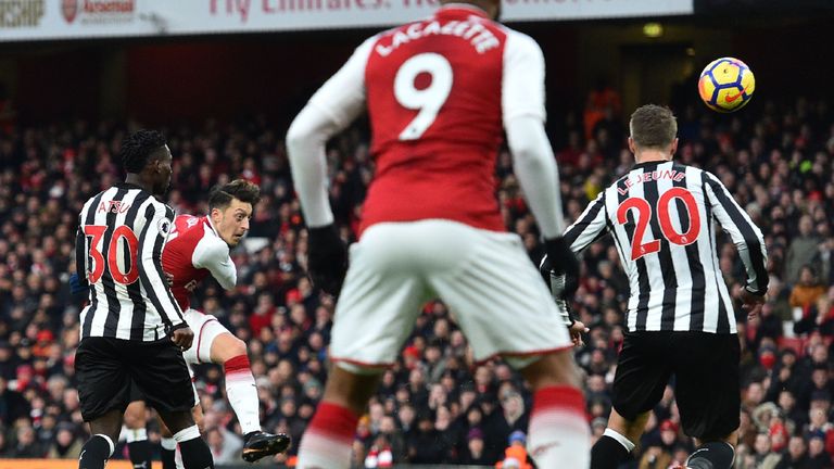 Mesut Ozil hits a left-footed volley to put Arsenal in front at the Emirates Stadium