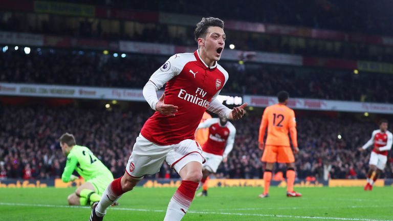 Mesut Ozil celebrates after giving Arsenal a 3-2 lead at home to Liverpool