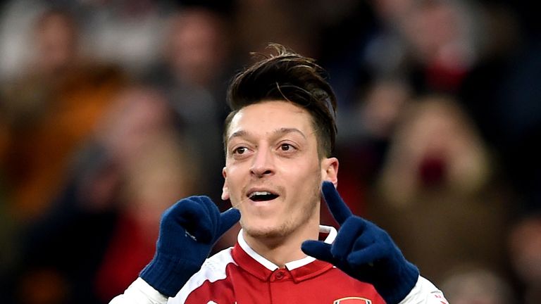 Mesut Ozil celebrates scoring his side's first goal of the game