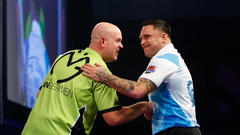 Michael van Gerwen is congratulated on his victory by Gerwyn Price on day eleven of the William Hill World Darts Championship
