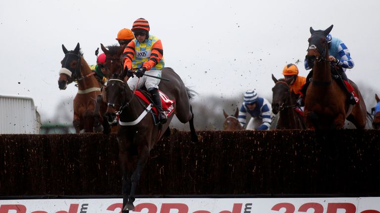 Might Bite ridden by Nico de Boinville clear an early fence before going on to win The 32Red King George VI Steeple Chase Race run during the 32Red Winter 