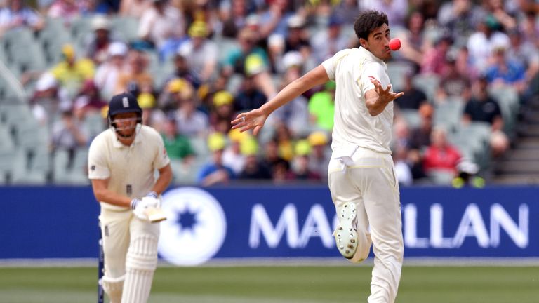 Australian paceman Mitchell Starc (R) takes a catch to dismiss England batsman Jonny Bairstow (L) on the third day of the second Ashes cricket Test match i