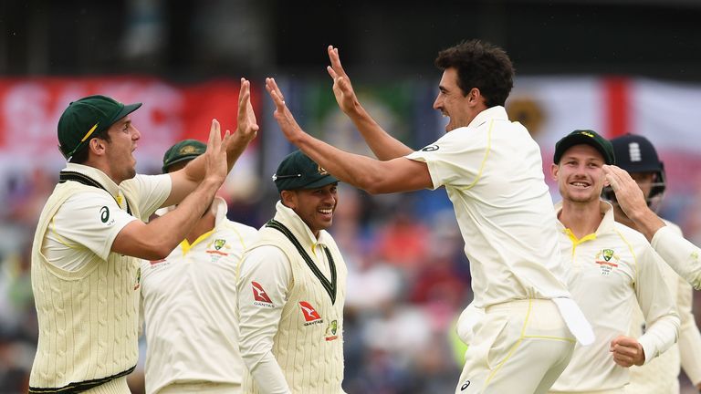 PERTH, AUSTRALIA - DECEMBER 17:  Mitchell Starc of Australia is congratulated by team mates after getting the wicket of James Vince of England during day f