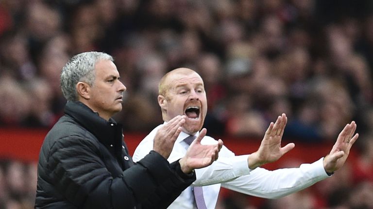 Manchester United's Portuguese manager Jose Mourinho (L) and Burnley's English manager Sean Dyche (R) gestures to their respective players on the touchline