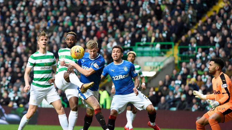 Moussa Dembele attemps a shot on goal under pressure from Ross McCrorie