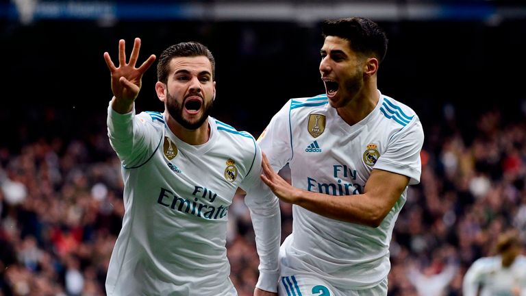 Nacho Fernandez celebrates with Real Madrid midfielder Marco Asensio (R) after scoring 