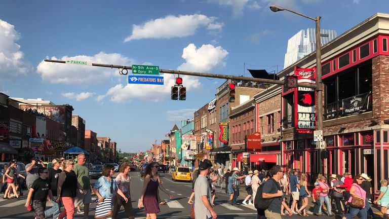 People walk on Broadway Avenue in Nashville, Tennessee, on August 19, 2017. / AFP PHOTO / Daniel SLIM        (Photo credit should read DANIEL SLIM/AFP/Gett