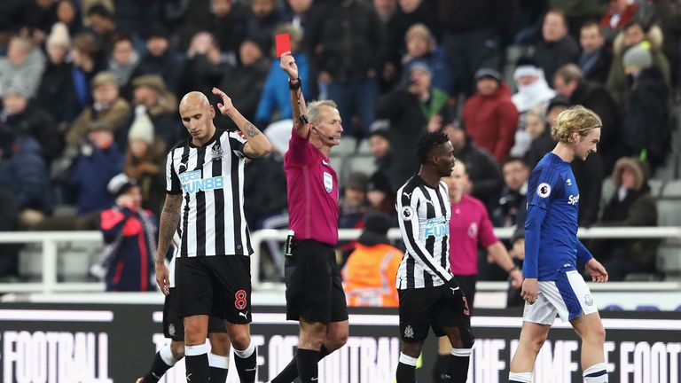 NEWCASTLE UPON TYNE, ENGLAND - DECEMBER 13: Jonjo Shelvey of Newcastle United is shown a red card by referee by Martin Atkinson during the Premier League m