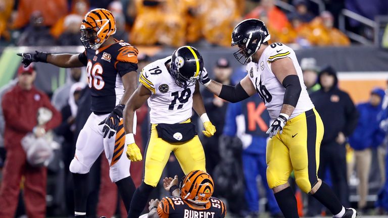 JuJu Smith-Schuster of the Steelers stands over Vontaze Burfict of the Bengals