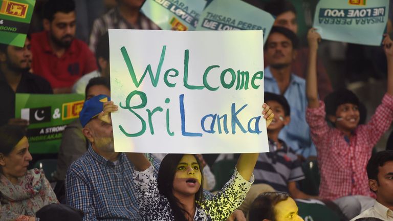 Pakistani spectator holds a placard while cheering during the T20 cricket match between Pakistan and Sri Lanka at the Gaddafi Cricket Stadium in Lahore on 