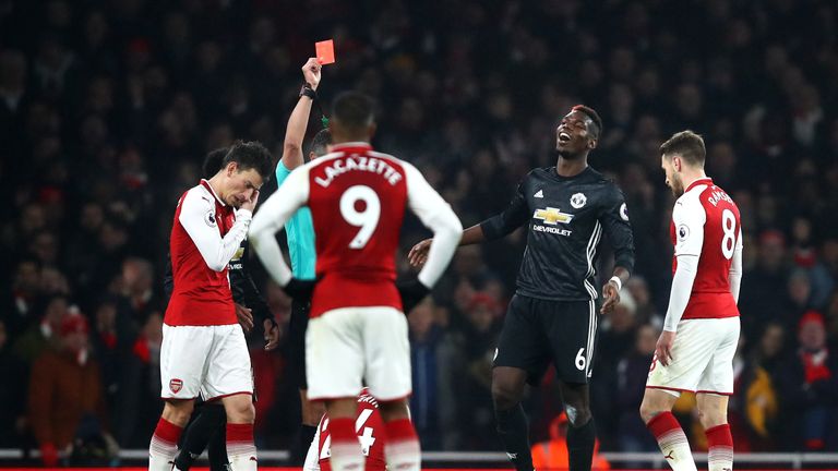 Paul Pogba of Manchester United is shown a red card by referee Andre Marriner (obscure)