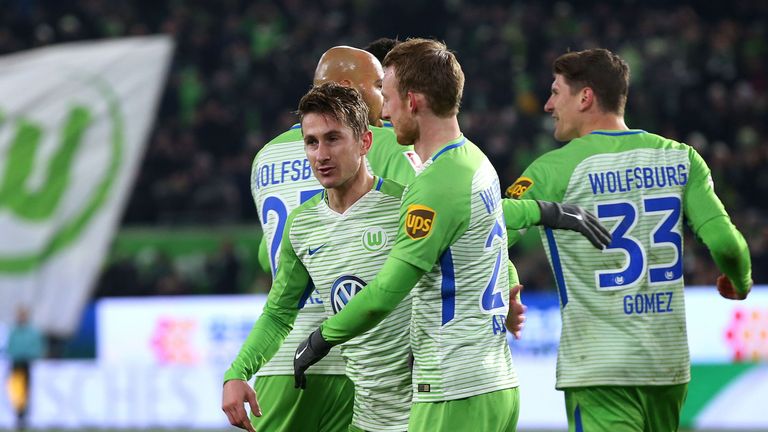 Wolfsburg's Dutch defender Paul Verhaegh celebrates after scoring a penalty with John Anthony Brooks (L), Maximilian Arnold and Mario Gomez.